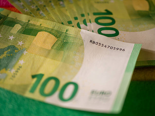 istock Euro Banknotes Piled Together on Colorful Background 2207253717