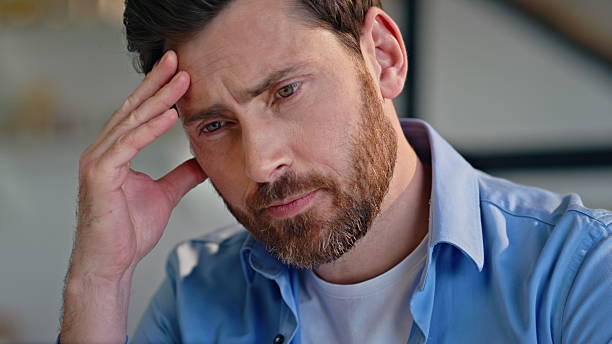 istock Closeup tensed employee thinking work crisis at workplace. Businessman pondering 2207255335