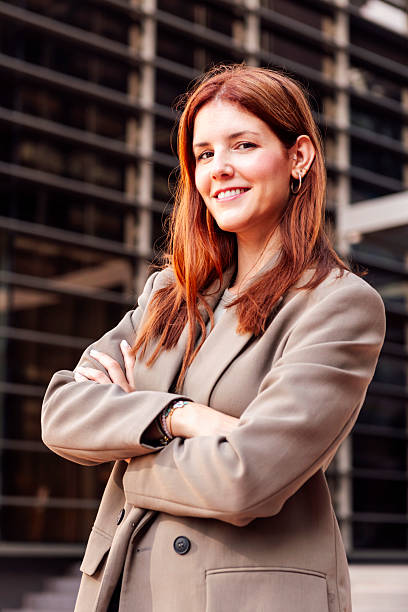 istock smiling business woman in front office building 2207255508