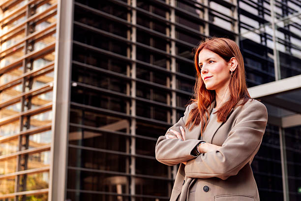 istock woman with arms crossed in front office building 2207255512