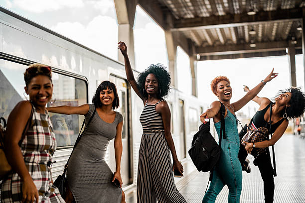 istock Group of young women having fun on a train station platform 2207257003