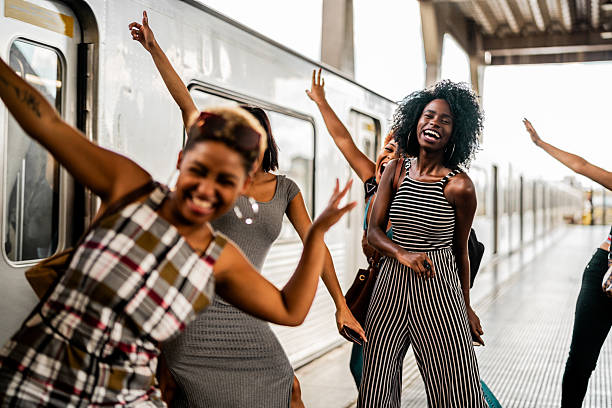 istock Group of young women having fun on a train station platform 2207257151