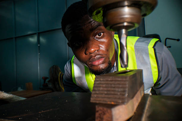 istock A focused engineer operating a heavy-duty drill machine, wearing a safety vest. The worker precision, determination, and industrial expertise, emphasizing workplace safety and machinery handling. 2207257180