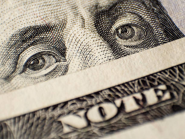 istock Eyes on dollar bill as an idea for protective face mask 2207257242