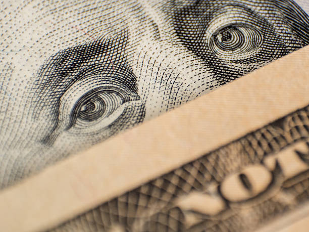 istock Eyes on dollar bill as an idea for protective face mask 2207257247