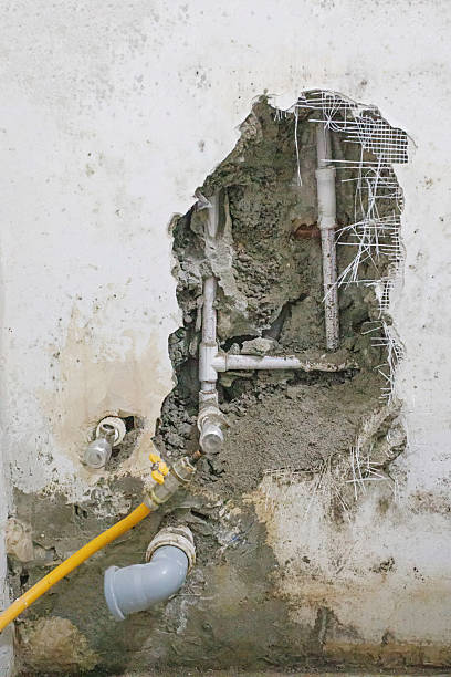 istock Hole in old building, drain pipes, renovating plumbing 2207265323