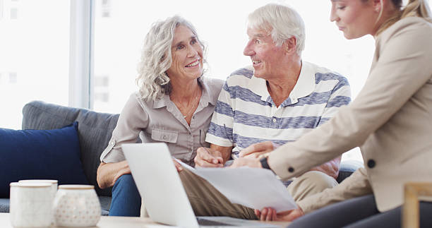 istock Senior, happy couple or documents with financial advisor or laptop for retirement plan, annuity or insurance. Elderly man, woman or accountant with paperwork for discussion on pension funds or assets 2207265557
