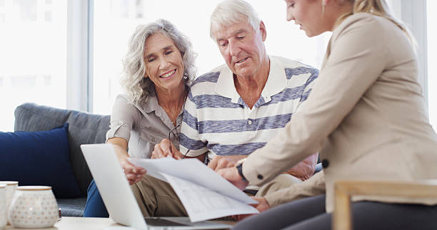 istock Happy, elderly couple or documents with financial advisor or laptop for retirement plan, annuity or insurance. Senior man, woman or accountant with paperwork for discussion on pension funds or assets 2207265579