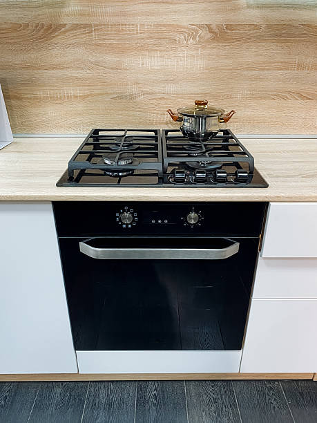 istock A sleek black oven is elegantly placed on a traditional gas stove, creating a stunning centerpiece in the vibrant kitchen with harmoniously showcased essential appliances 2207275139