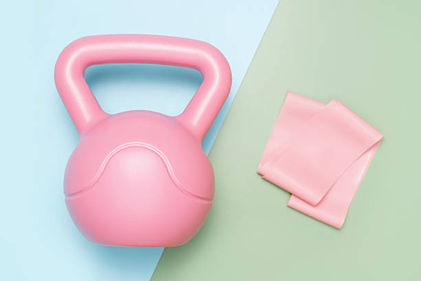 istock Kettlebell and elastic band on a blue and green background top view close-up. 2207278480