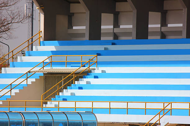 a section of a grandstand filled with light blue seats in a sports arena or stadium.