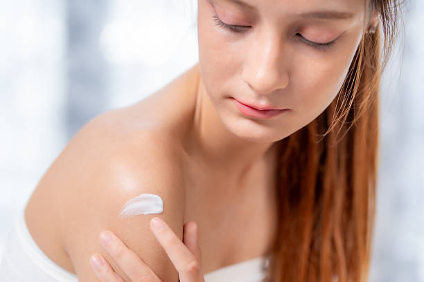 istock Nurturing skin care is essential for maintaining healthy glow and softness. This captures young woman applying cream to her shoulder, emphasizing importance of skin care in daily routines 2207280791