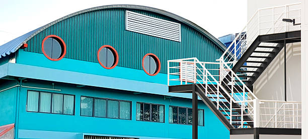 istock out door exit fire stairs of building with exterior mixed design the building using corrugated metal roof window frame circle shape and square ventilation vent 2207280807