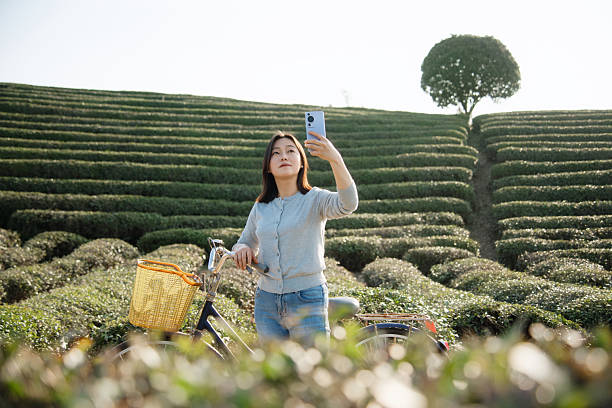 istock Asian woman is using smart phone take picture 2207286275