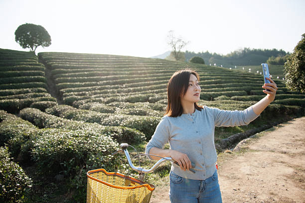 istock Asian woman is using smart phone take picture 2207286430