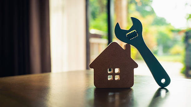 istock Model house and wrench, home services. Home repairs concept. 2207287871