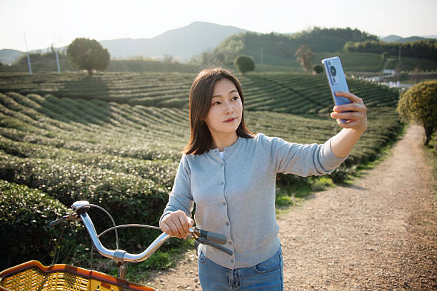 istock Asian woman is using smart phone take picture 2207288622