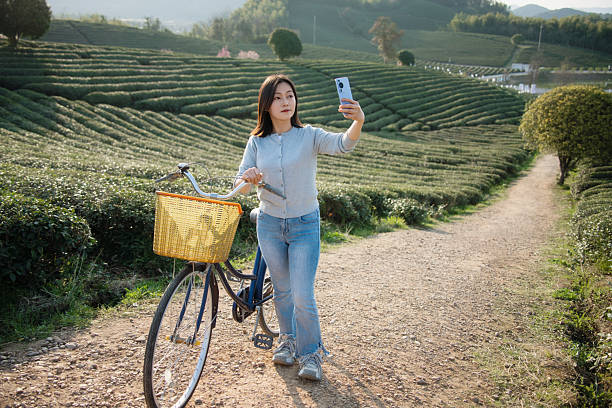 istock Asian woman is using smart phone take picture 2207288625