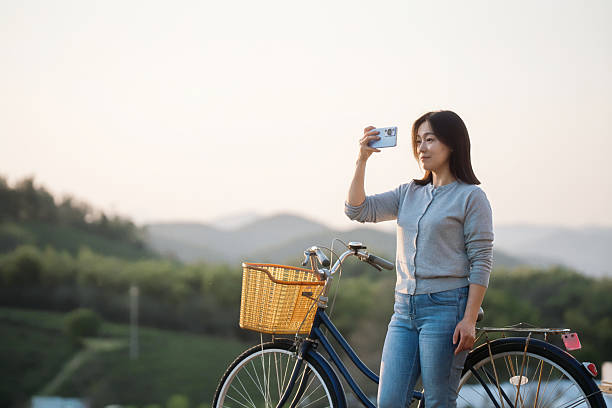 istock Asian woman is using smart phone take picture 2207290396