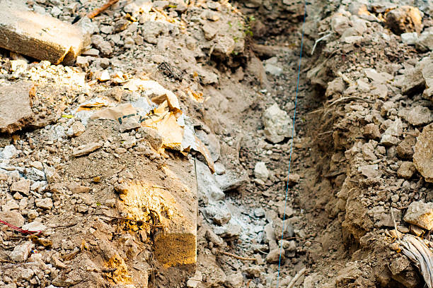 istock Construction Trench with Loose Dirt and Scattered Debris 2207291506