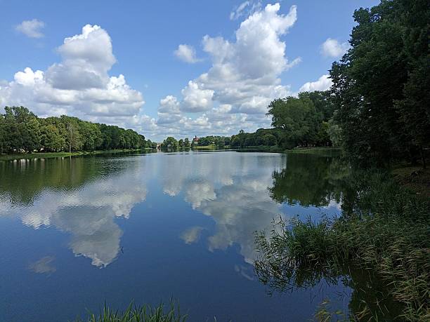 istock Beautiful lake with reflection of white clouds 2207291607
