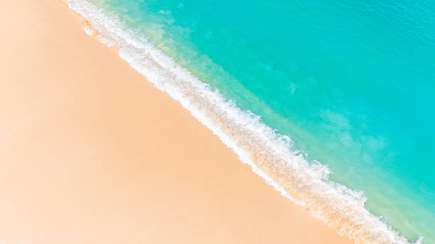 istock Stunning summer seascape with gentle waves rolling onto an untouched white sand beach. 2207294980