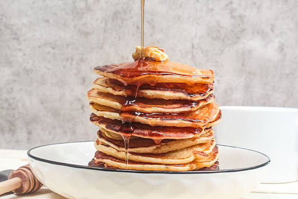 istock honey poured on a stack of pancakes on a plate 2207295507