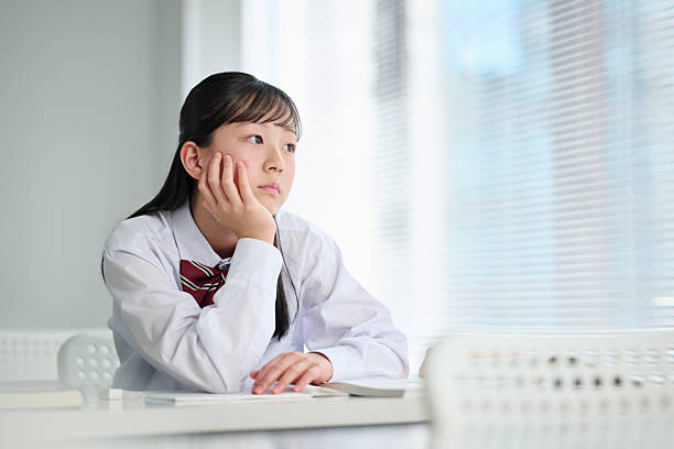 A junior high school girl thinking in class