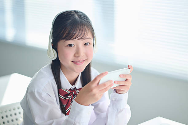 A junior high school girl taking a class on her smartphone