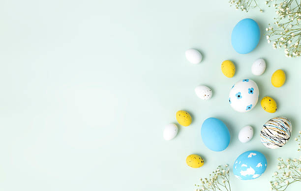 istock Blue yellow white colorful eggs on green empty space background, Ester holiday background, blank. 2207300360