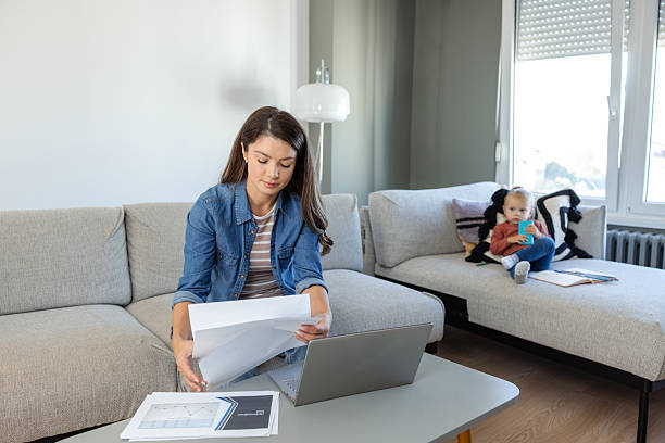 istock Mother multitasking work from home with her child playing nearby 2207301025