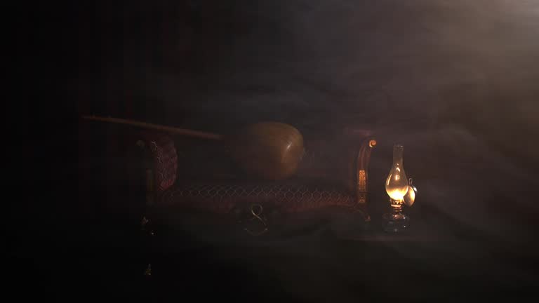 a foggy shooting concept in the studio with a musical instrument and a kerosene lamp