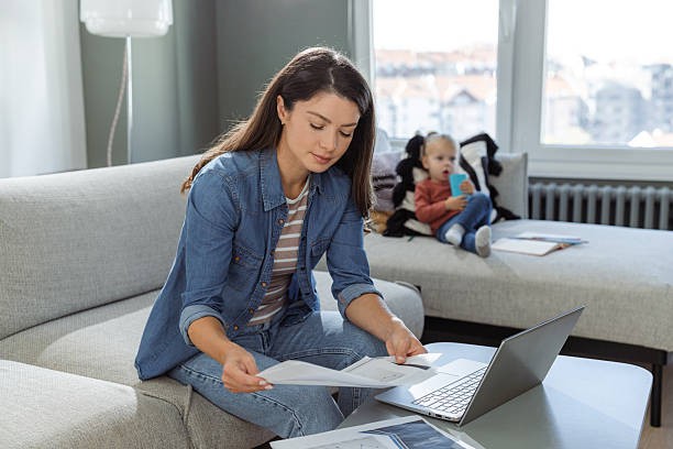 istock Mother multitasking work from home with her child playing nearby 2207301899