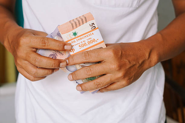 istock Holding Indonesian Rupiah Banknotes, Financial Wealth and Economic Prosperity 2207304670