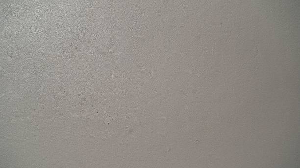 istock Gray concrete wall as background. Stone wall background. Smooth plastered wall. 2207306127