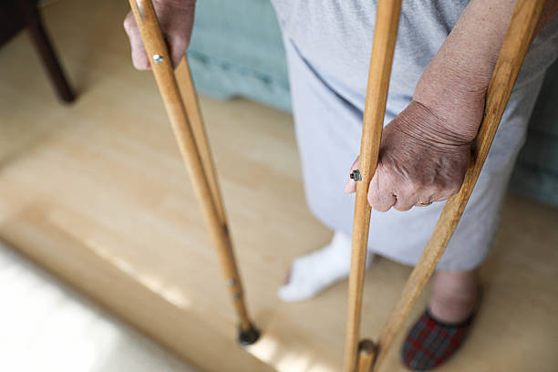 istock Close-up of an Elderly Woman's Hand Holding Crutches 2207306783