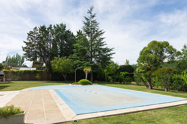 istock Summer pool covered with a blue tarp to protect the water from dirt. End or beginning of season, autumn or spring 2207306859