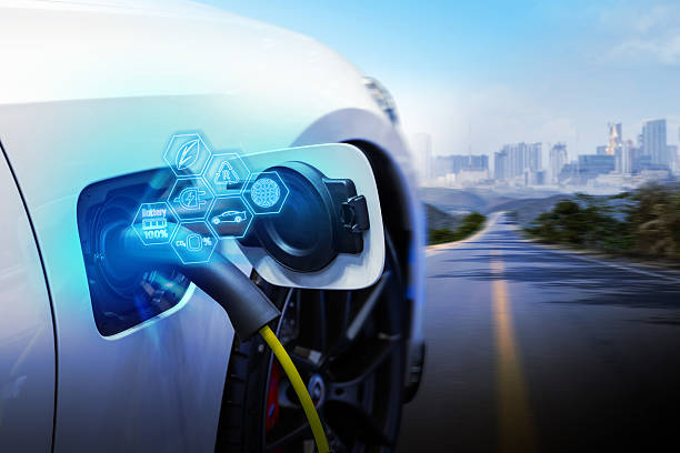 istock Power cable pump plug in charging power to electric vehicle EV car. 2207310818