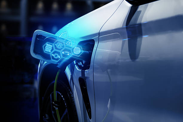 istock Power cable pump plug in charging power to electric vehicle EV car. 2207310827