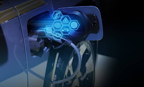istock Power cable pump plug in charging power to electric vehicle EV car. 2207310836