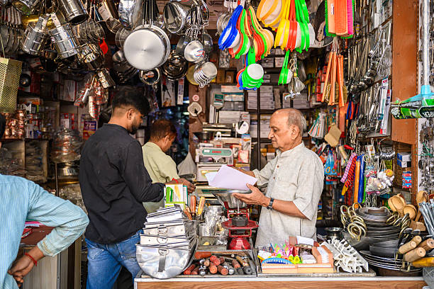 Delhi, India - November 6, 2024:  senior man standing in general store in old Delhi