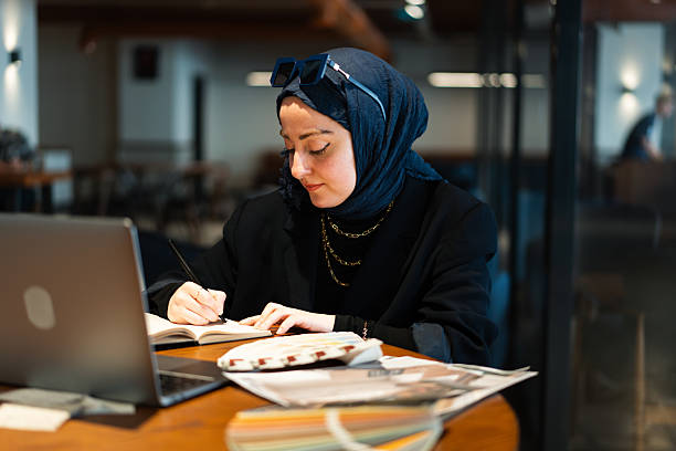istock Architect working remotely in modern cafe with color swatches 2207311253
