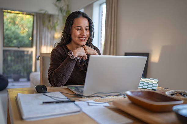 istock Woman Smiling at Laptop During Online Conversation 2207312799