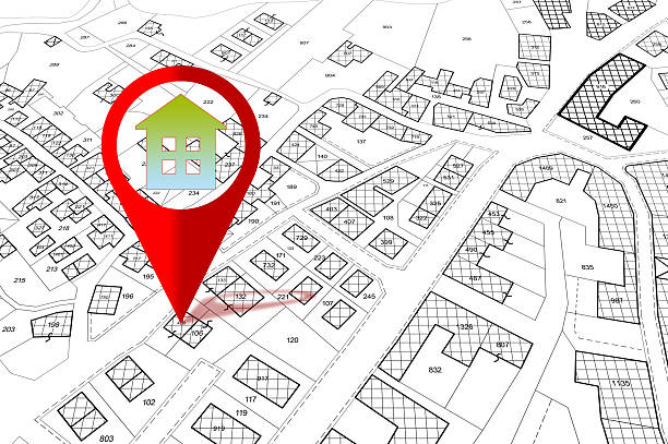 istock Searching new home - concept with an imaginary cadastral map of territory with buildings and home icon 2207312911