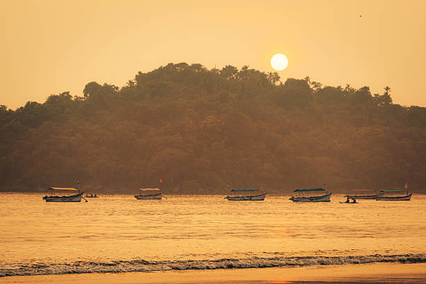 istock Serene Sunset Over Goa Beach With Boats and Silhouetted Trees 2207313586