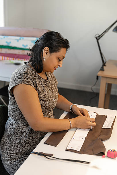 istock Beautiful Indian woman learning a new skill at a sewing School 2207313644