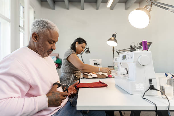 istock Handsome black man learning a new skill at a sewing School 2207313646
