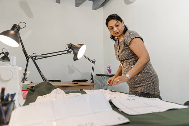 istock Beautiful Indian woman learning a new skill at a sewing School 2207313867