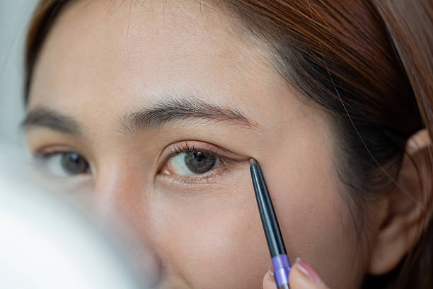 istock Eye Makeup and Precision. A woman applying eyeliner to accentuate her eyes. 2207314969