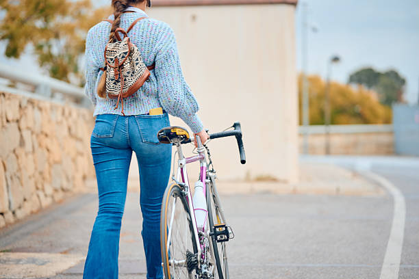 istock Cyclist walking with bicycle along a scenic path on a cloudy day 2207317962